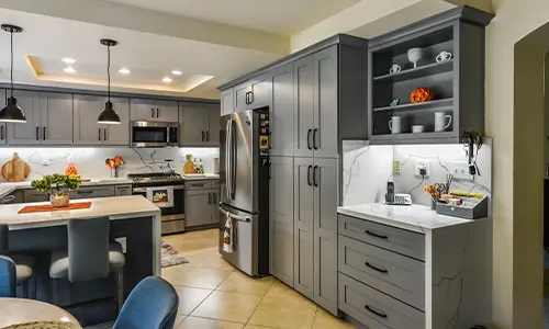 Kitchen interior showcasing cabinet painting and a stainless steel fridge